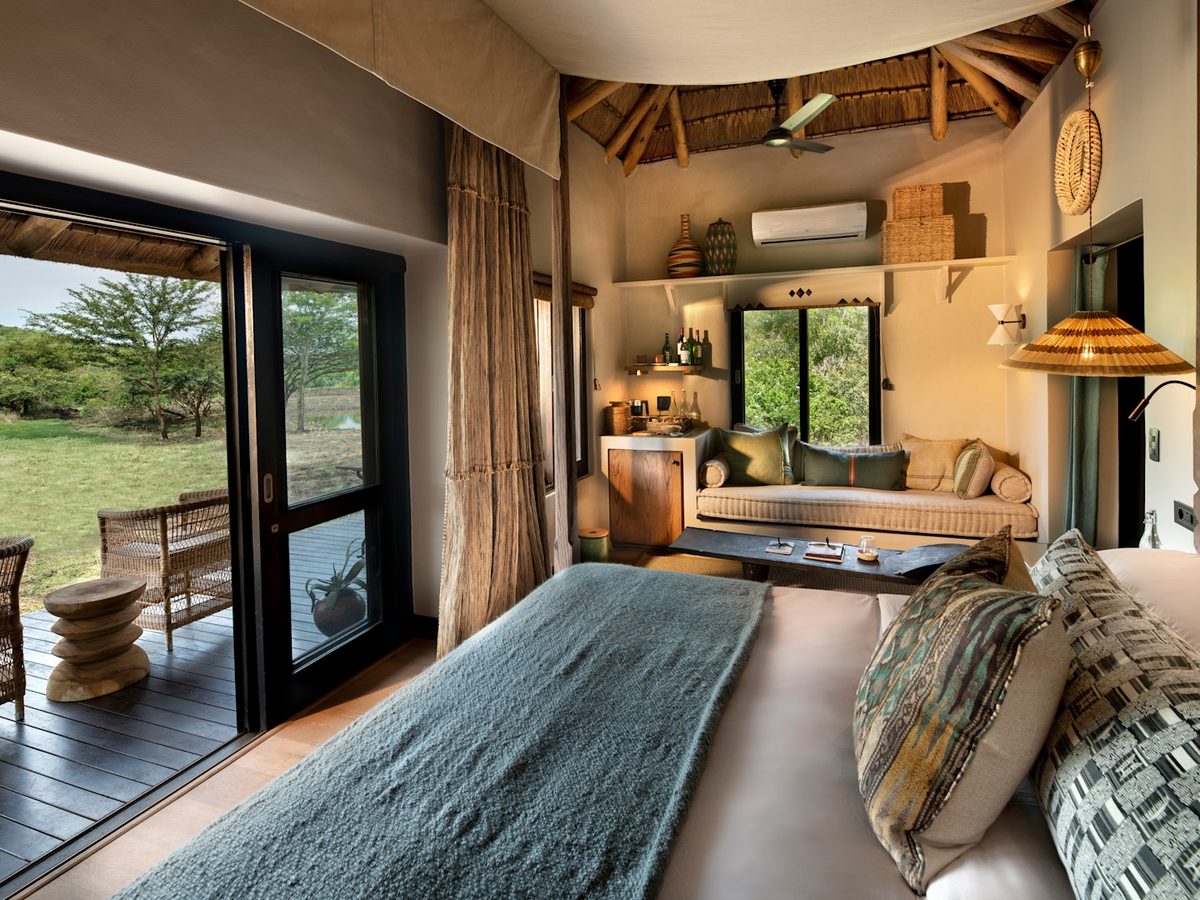Suite bedroom with private deck at andBeyond Phinda Zuka Lodge