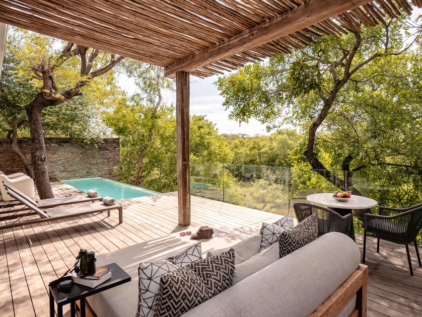 The private deck of a Superior Luxury Villa at Kapama Karula with a heated plunge pool, sun loungers and a shaded seating area