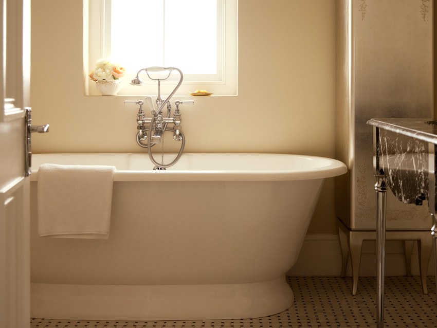A bathroom at the Mount Nelson with a freestanding bath beneath a window