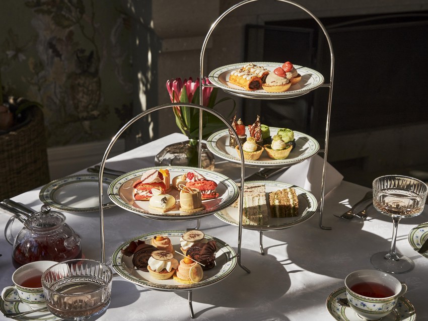 Afternoon tea at the Mount Nelson, a tiered stand of cakes and sandwiches with silver teapots