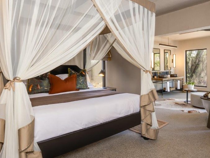 Suite bedroom with mosquito net at Sabi Sabi Bush Lodge